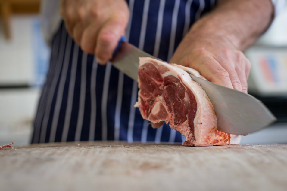 Butcher slicing meat